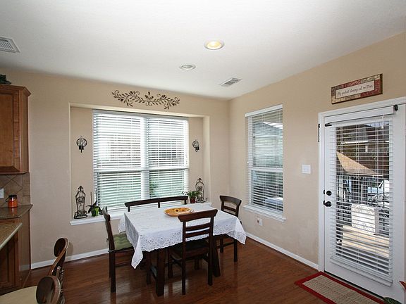 Extensive wood floors continue into the breakfast area.