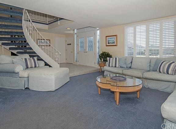 The dramatic spiral staircase opens to the entry with a spacious formal living room.
