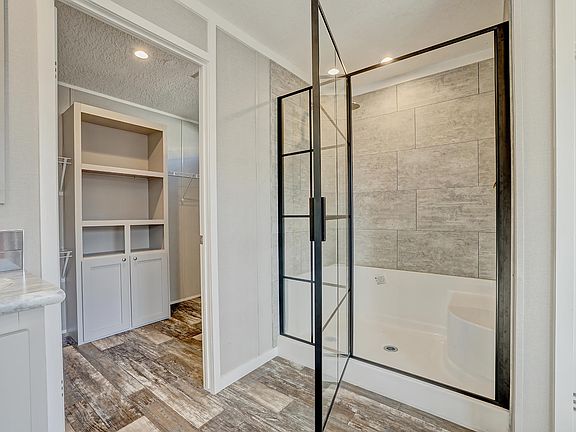 shower in master bath and entry to the walk in closet