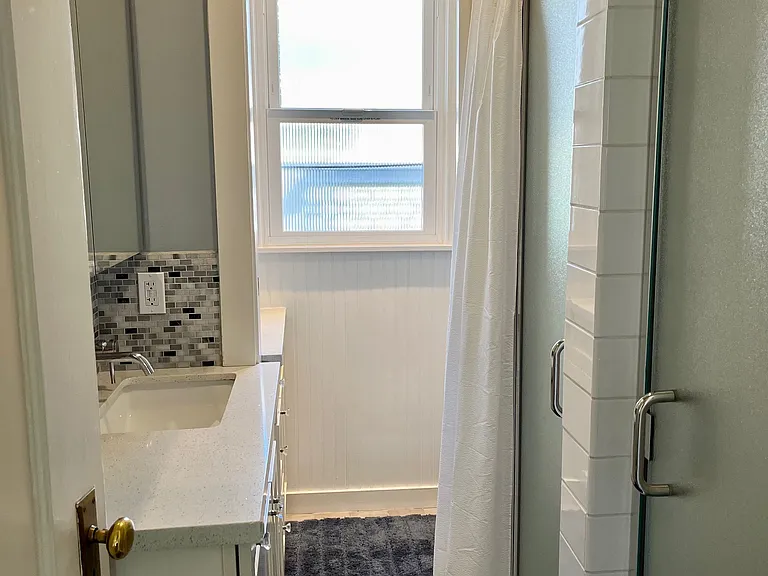 2nd floor female remodeled shared bath with double sinks and 2 showers