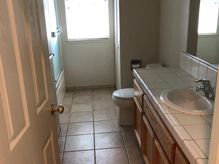 Hall bathroom includes washer/dryer unit and tub/shower combo.