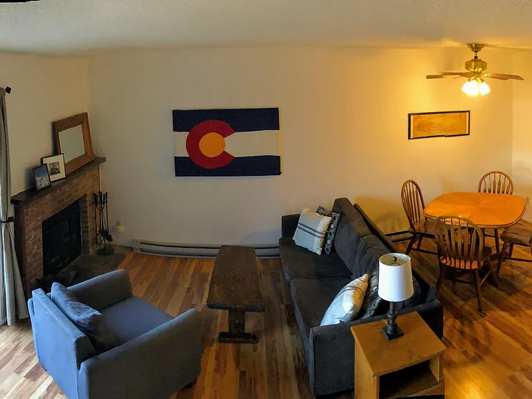 Open living and dining area with fireplace