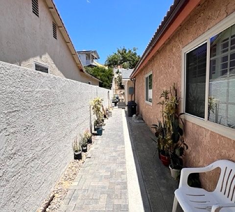 Walk way from front entrance to unit, behind main home.