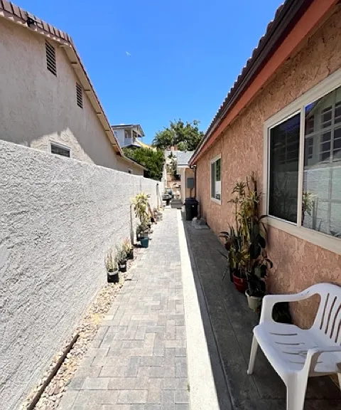 Walk way from front entrance to unit, behind main home.