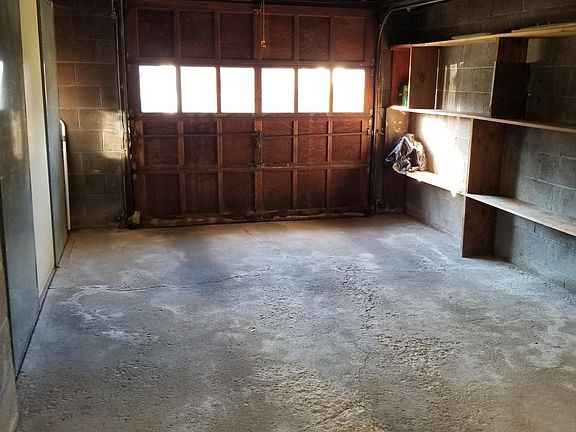 One car garage with opener, shelves for storage