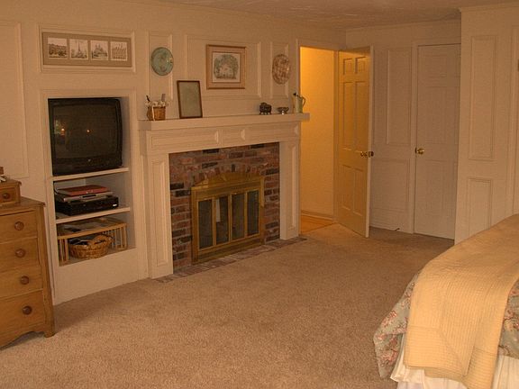 master with fireplace and custom wood detail wall panelling