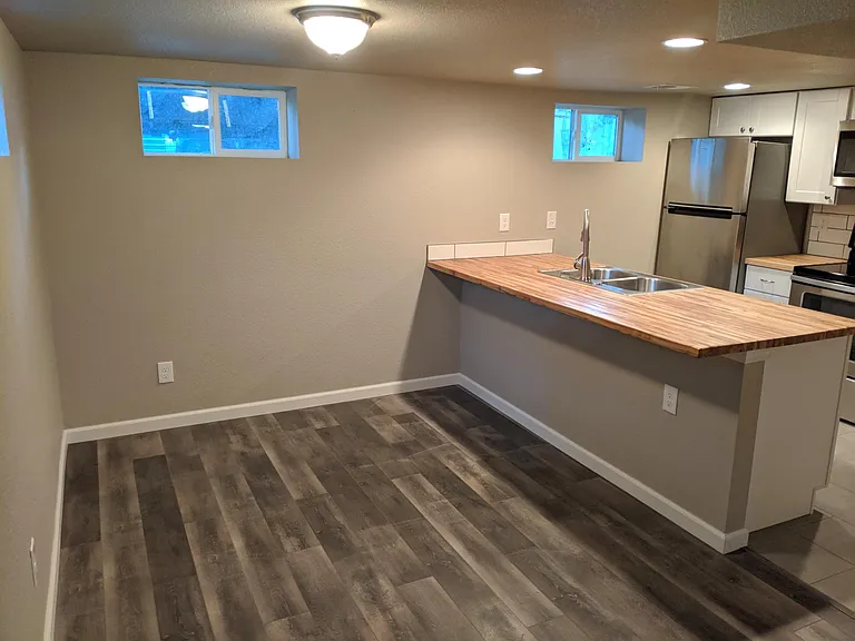 Dining area is 8x7.3 ft and has room for a dining room table in addition to stools at the eating bar.