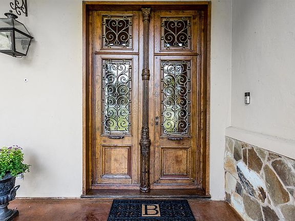 The first of those many unique features greets you at the double front doors. These antique doors are truly one-of-a-kind, being imported from France, they are from the 18th century! This French element sets the tone for this home's old-world Europea