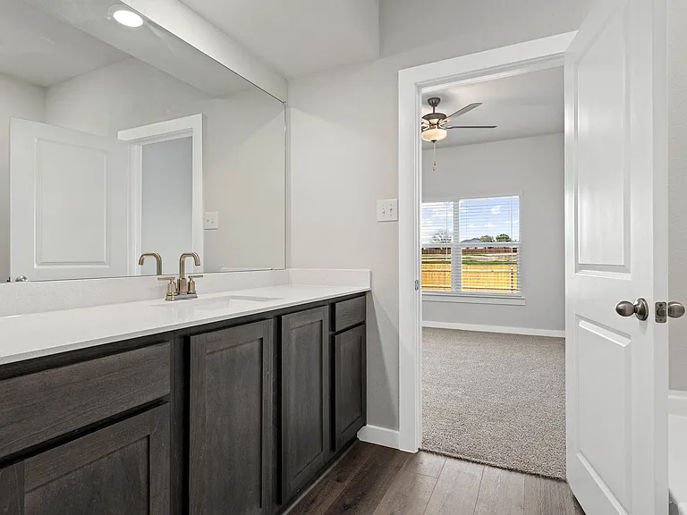 The master bathroom has a sprawling vanity.
