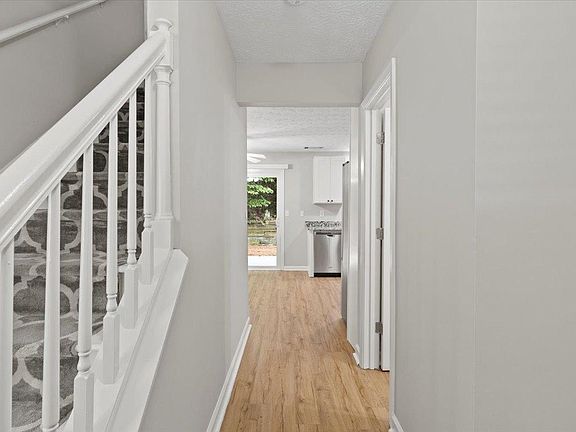 Half bath on the right. Kitchen at the end.