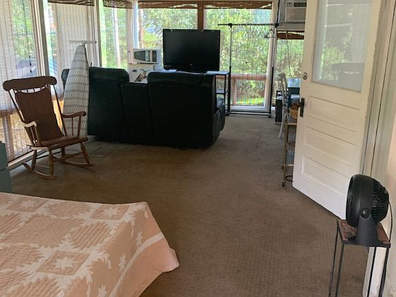 Sunroom from the private balcony entrance in the back of the property and at the top of a staircase.