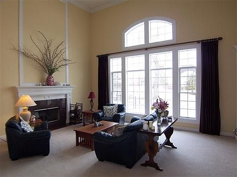 Dramatic 2-story great room is enhanced by a wall of windows and a gas fireplace