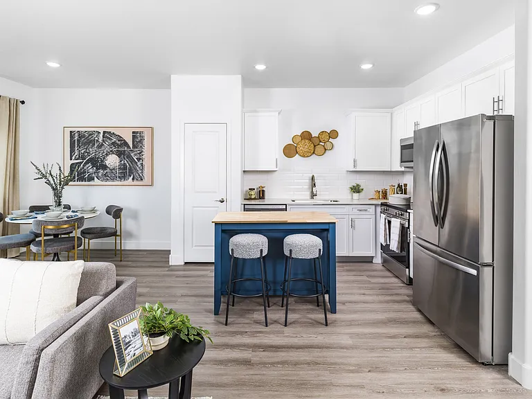 Your dream kitchen awaits at Aster Ridge. Enjoy quartz countertops, white shaker cabinets, and a stunning tile backsplash, all complemented by ENERGY STAR_ stainless steel appliances.