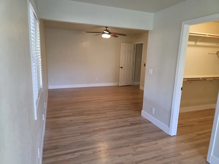 Large master suite, walk-in closet, full bath with shower, outside access, hardwood floors.