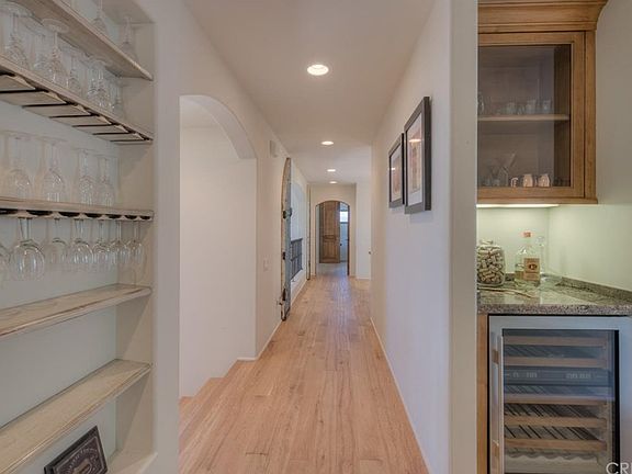 Dry bar with built-in wine fridge, next to butler'