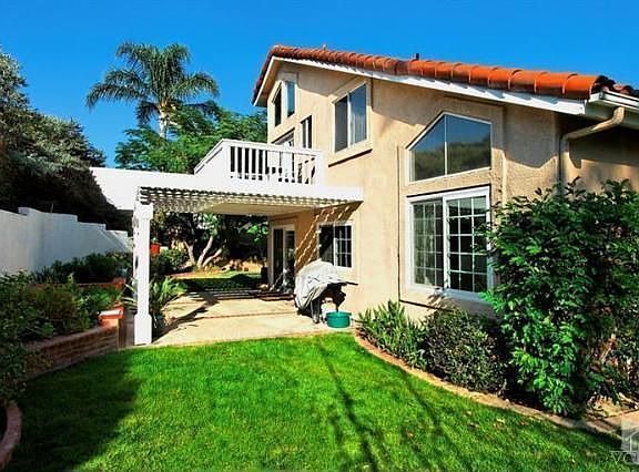 Backyard with patio overhang and balcony off master bedroom
