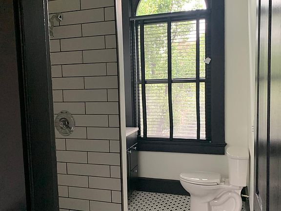 Custom tile by Nix, custom blinds, quartz countertop soaring ceiling with mirror to match