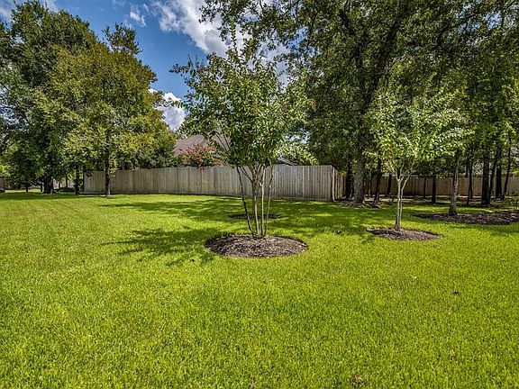Rare find with only one adjacent neighbor. Spacious corner offers more yard beyond fence, view to front is wooded and rear has a Green space.