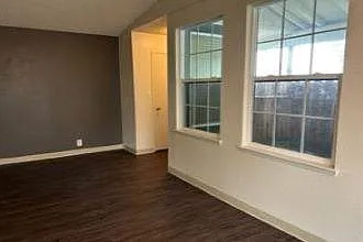 Living room with windows overlooking front bonus enclosed patio.