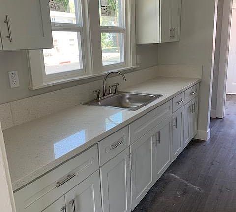 Large kitchen completely renovated with new kitchen range and refrigerator.