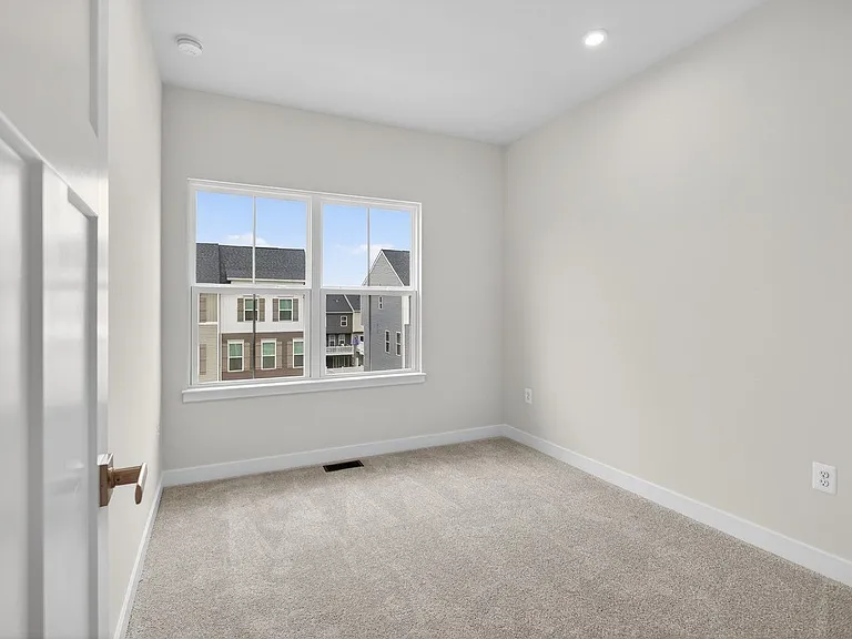 View into bedroom 3 with plush carpeting
