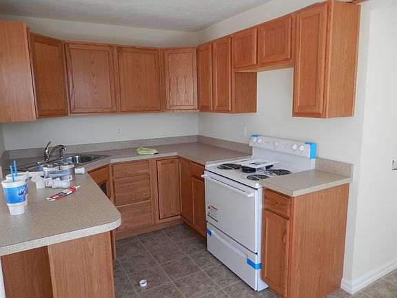 Kitchen with lots of cabinets, stove and sink