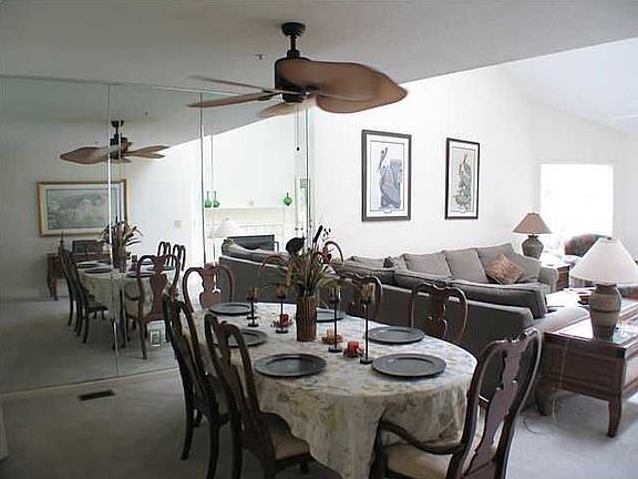 Large open dining area connected to the living room featuring a wet bar.