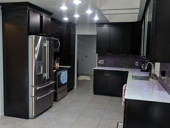 Quartz countertops and espresso wood cabinets