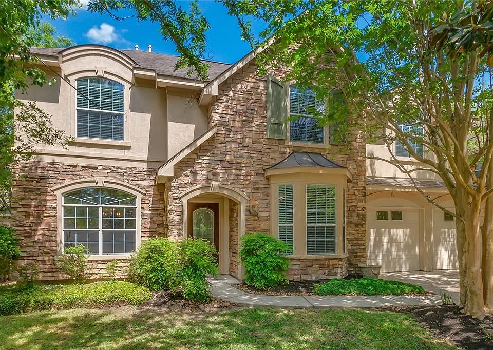 Welcome home to this gorgeous stone and stucco home surrounded by mature trees and landscaping