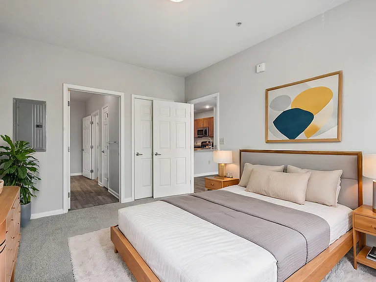 Serene primary bedroom offering an ensuite bathroom and large closet, it is the perfect blend of style and comfort. The room's clean lines and calming neutral palette create an ideal sanctuary for rest and relaxation. Serene primary bedroom offering an en