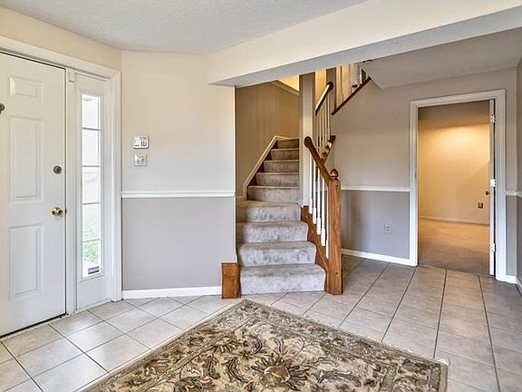 Entry way leads to finishes game room, upstairs to main living area, or garage acess.