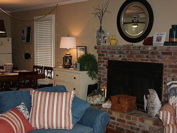 Den with wood fireplace