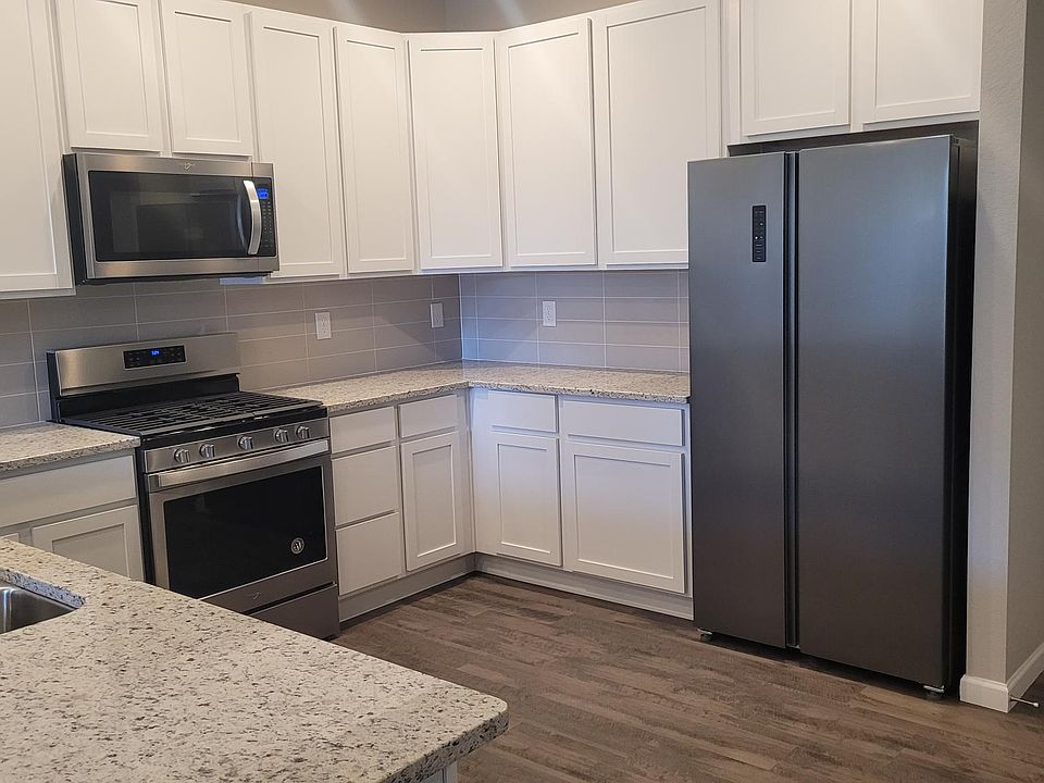 Huge and beautiful kitchen with stainless appliances and bar seating