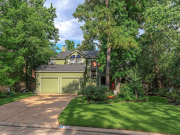 A covered front porch overlooks the serene yard. 2 car attached garage and double-wide driveway will