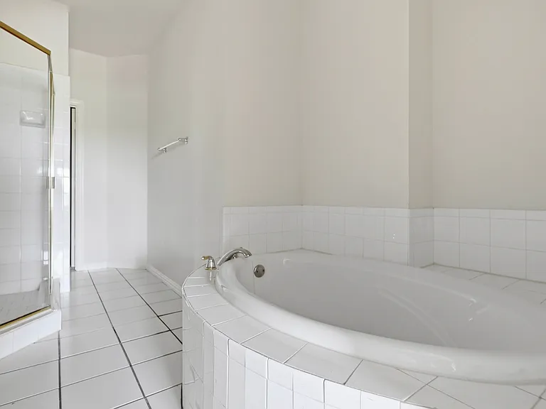 primary garden tub and separate shower stall