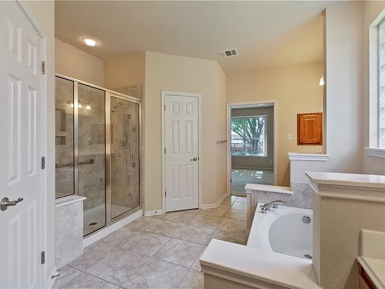 Master bathroom with double vanities, garden tub and a shower