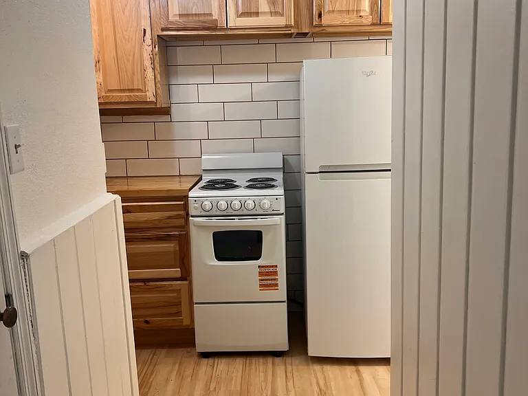 Brand new kitchenette cabinets and stove