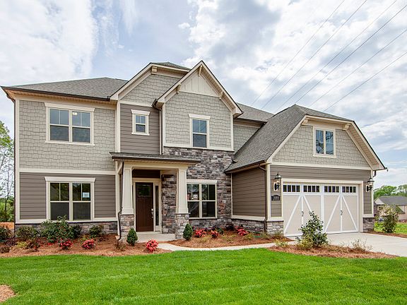 Worthington Exterior 3 features stone, siding, shakes, covered front door and 2 car front load garag