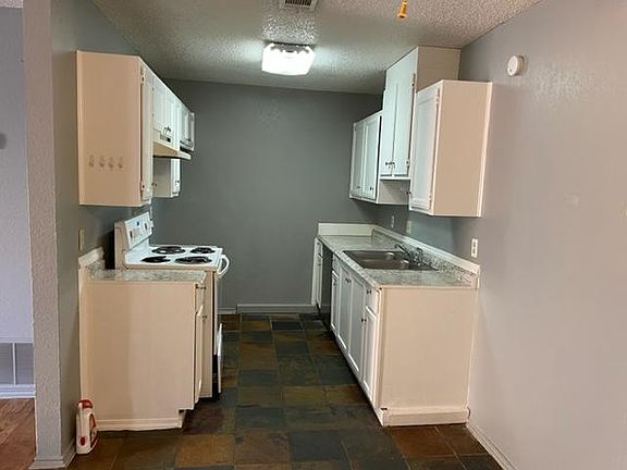 This cozy, no-fuss kitchen offers everything you need with a gas stove, functional dishwasher, and plenty of natural light_perfect for easy everyday cooking. Its simple layout makes meal prep a breeze.