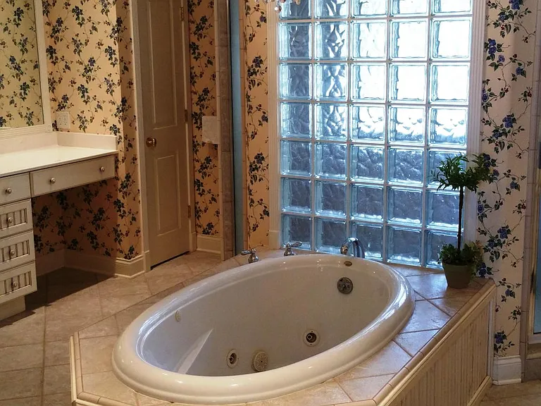 Master BA w Jacuzzi tub and double headed shower. Note: the wallpaper has been removed and the walls are now painted a beautiful linen white.