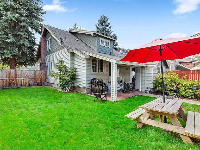 Back yard with BBQ, porch swing and picnic table.
Fully fenced in yard.