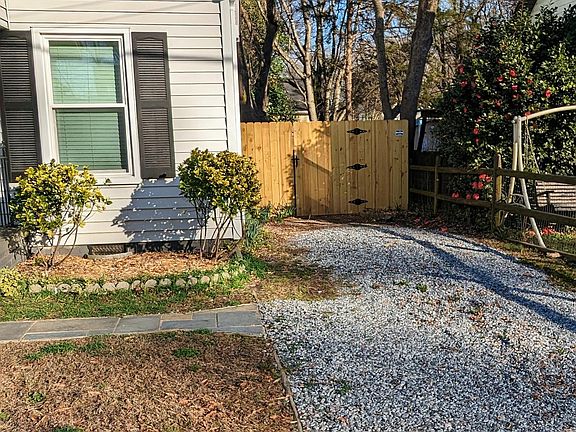 Driveway and fenced backyard