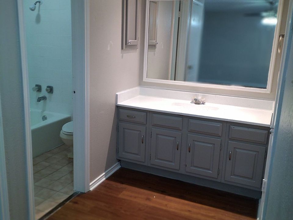 vanity in master bedroom with private restroom