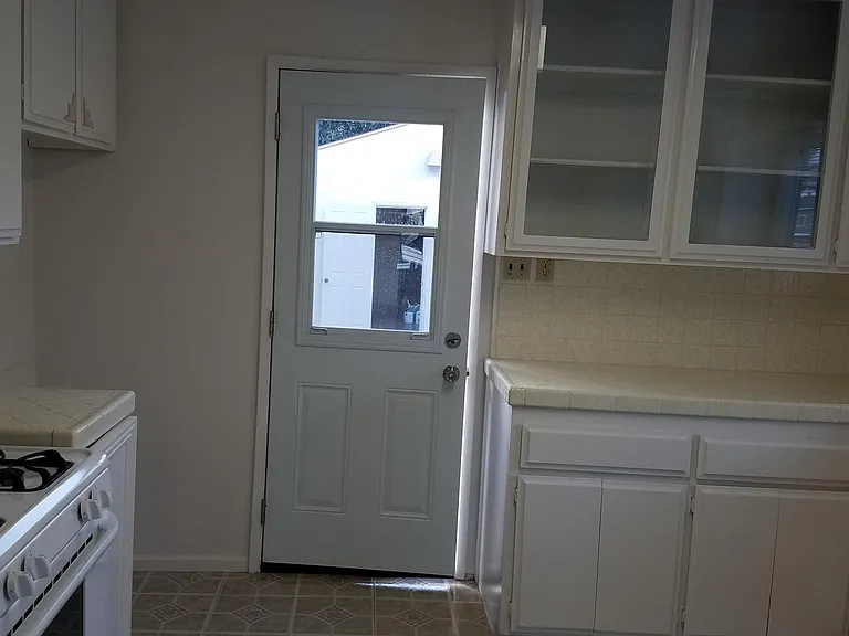 Tons of kitchen cabinet space and a build-in custom china cabinet. Sliding glass window in back door for great breezes.