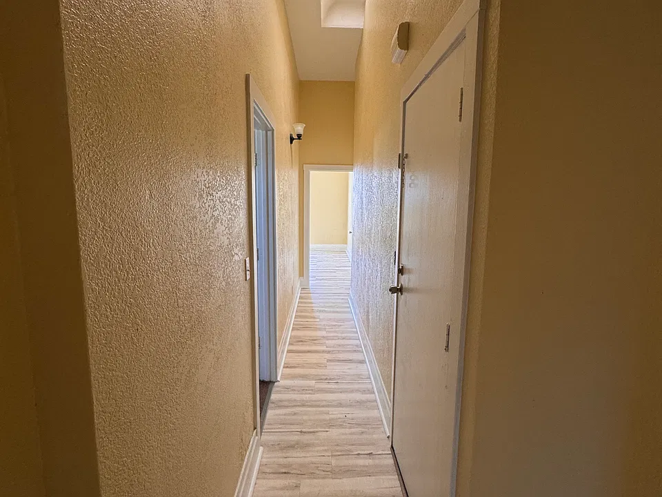 Entrance/Hallway facing towards living room. Bedroom #1 to the left.