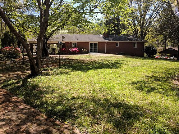 Back of home with brick walk