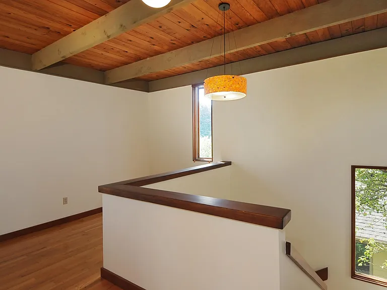Stairs to top floor, and dining nook.