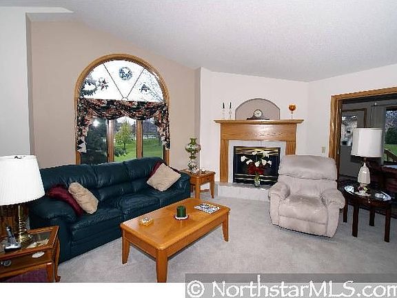 The formal living room offers a wood surround around the fireplace with a nich