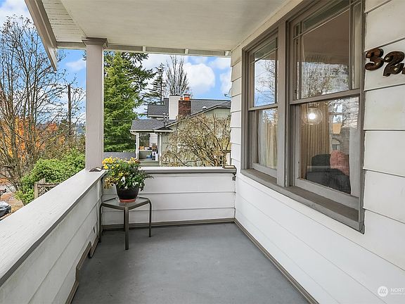 This spacious front porch/deck overlooks the neighborhood and leads directly into the living room.>
