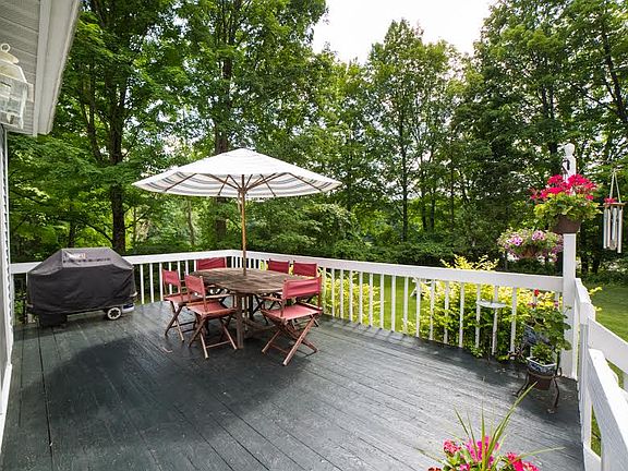 Deck overlooks yard and pond